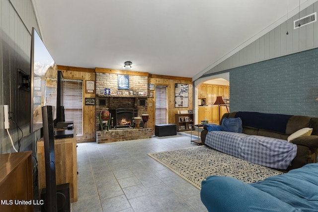5539 Gates Ave, Long Beach, MS 39560 - living area featuring wooden walls, arched walkways, a brick fireplace, and brick wall