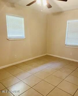 3908 Wildwood Rd, Moss Point, MS 39562 - empty room with a ceiling fan and light tile patterned floors