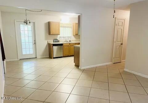 3908 Wildwood Rd, Moss Point, MS 39562 - kitchen featuring dishwasher, light countertops, light tile patterned floors, and plenty of natural light