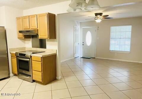 3908 Wildwood Rd, Moss Point, MS 39562 - kitchen with stainless steel appliances, under cabinet range hood, light countertops, a ceiling fan, and light tile patterned floors