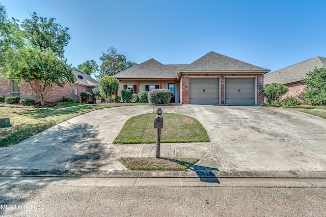 view of front of property featuring a garage and a front lawn