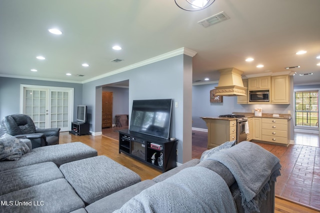 living room featuring crown molding and light wood-type flooring