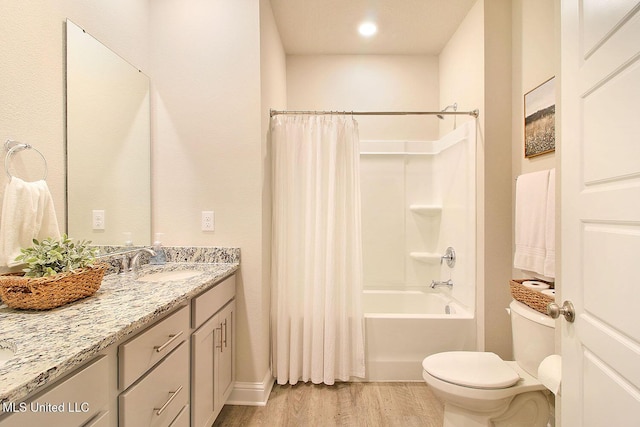 full bathroom with wood-type flooring, toilet, shower / tub combo with curtain, and vanity