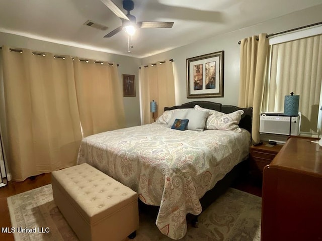 bedroom with ceiling fan, hardwood / wood-style floors, and cooling unit