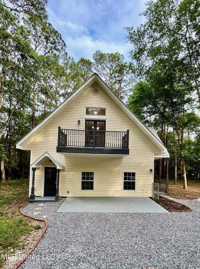 view of front of home featuring a balcony and a patio
