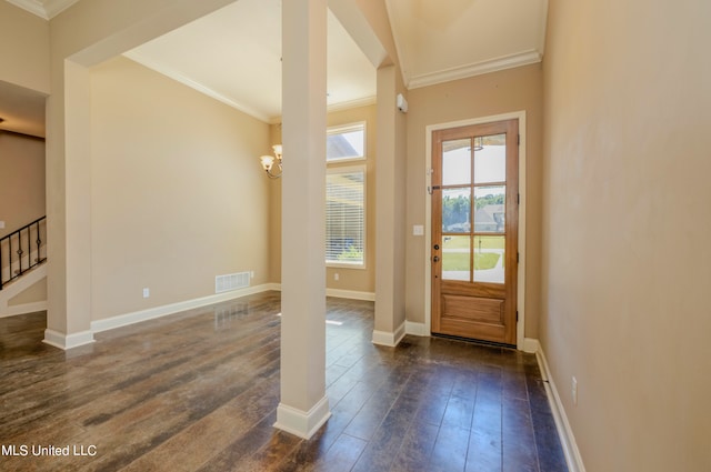 doorway to outside with ornamental molding and dark hardwood / wood-style flooring