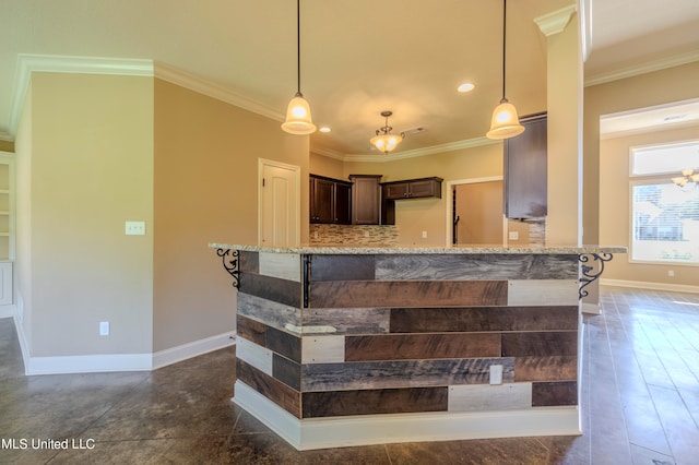 interior space featuring light stone counters, ornamental molding, dark brown cabinetry, and pendant lighting