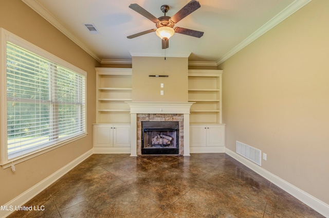 unfurnished living room with crown molding, a stone fireplace, built in features, and ceiling fan