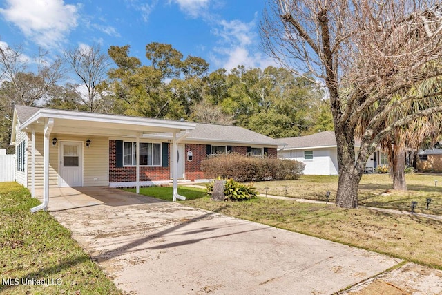 single story home featuring driveway, brick siding, and a front lawn