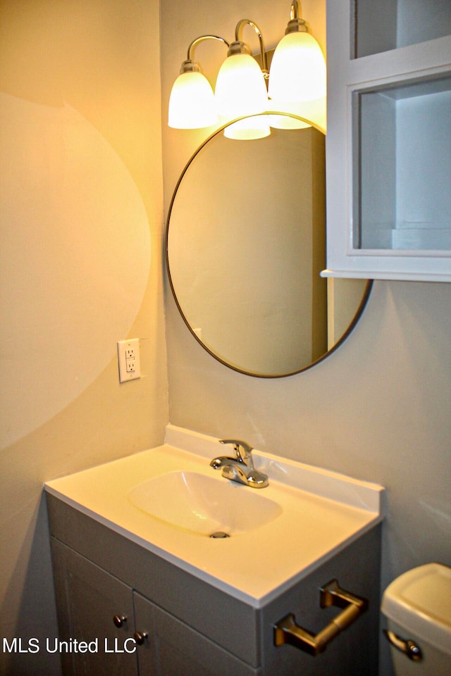 bathroom featuring vanity and toilet