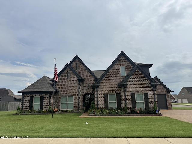 6819 Hawks Vw, Olive Branch, MS 38654 - view of front facade featuring brick siding, a front lawn, driveway, a garage, and a shingled roof