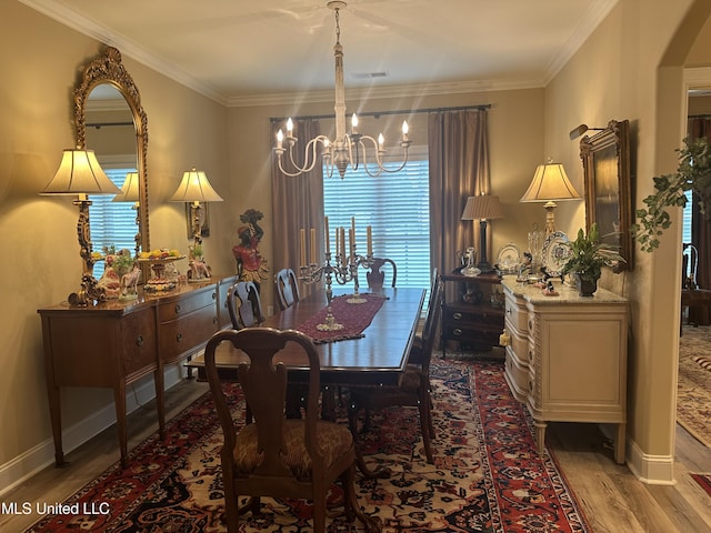 6819 Hawks Vw, Olive Branch, MS 38654 - dining space with a chandelier, wood finished floors, plenty of natural light, baseboards, and crown molding