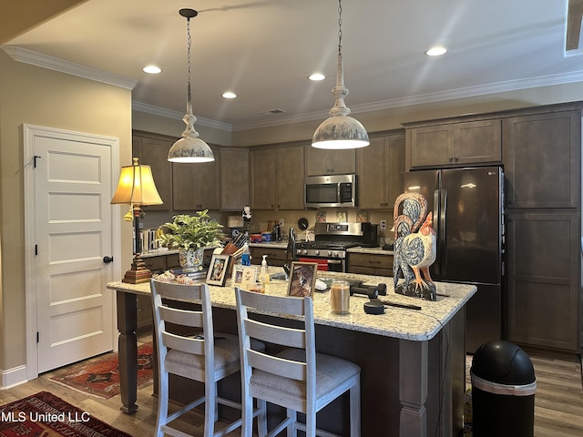 6819 Hawks Vw, Olive Branch, MS 38654 - kitchen with stainless steel appliances, dark wood-style floors, dark brown cabinets, a breakfast bar, and ornamental molding