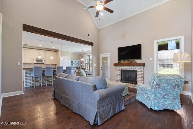 living area with high vaulted ceiling, a fireplace, crown molding, ceiling fan, and dark wood-style flooring