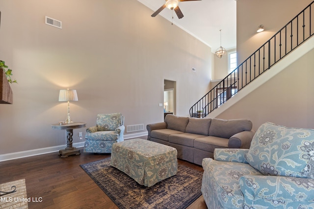 living area featuring stairway, wood finished floors, visible vents, baseboards, and ceiling fan