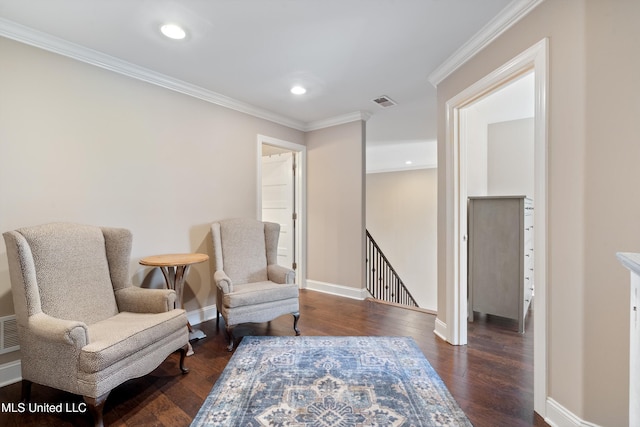 living area with dark wood-type flooring, an upstairs landing, baseboards, and ornamental molding