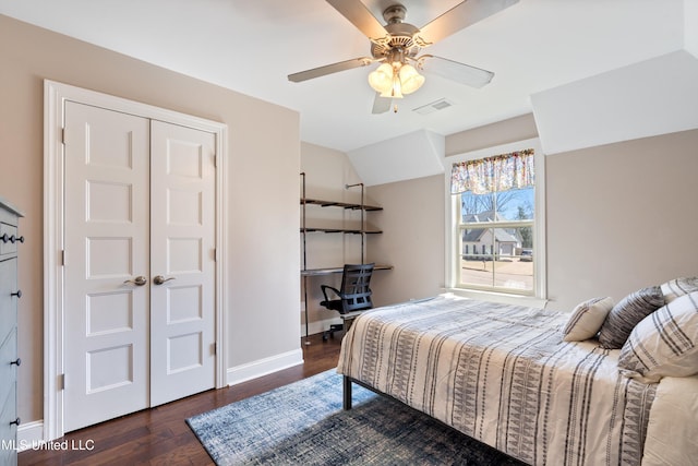 bedroom featuring visible vents, baseboards, vaulted ceiling, wood finished floors, and a ceiling fan