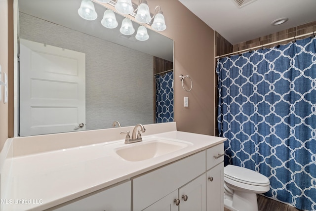 bathroom featuring a shower with shower curtain, toilet, and vanity