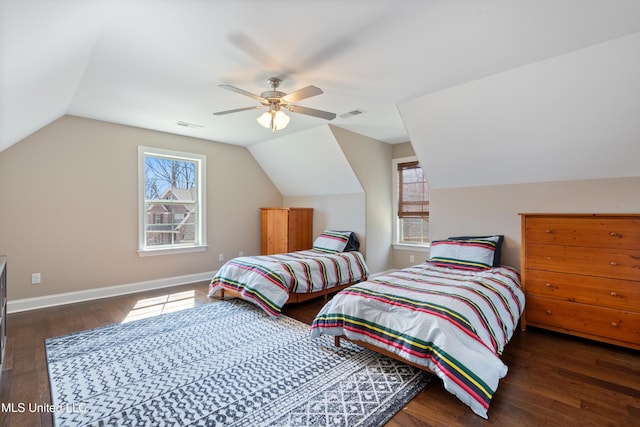 bedroom featuring vaulted ceiling, visible vents, baseboards, and wood finished floors