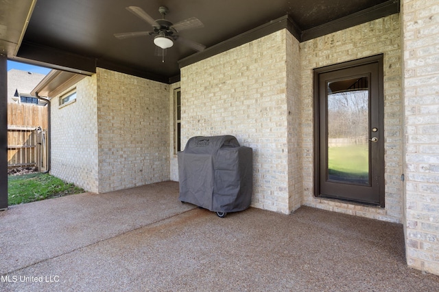 view of patio featuring grilling area, ceiling fan, and fence