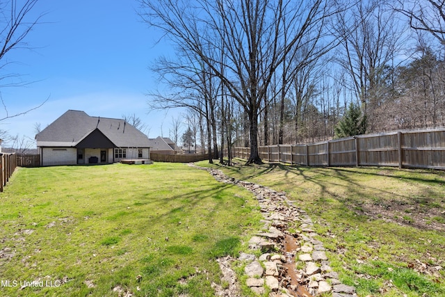 view of yard with a fenced backyard