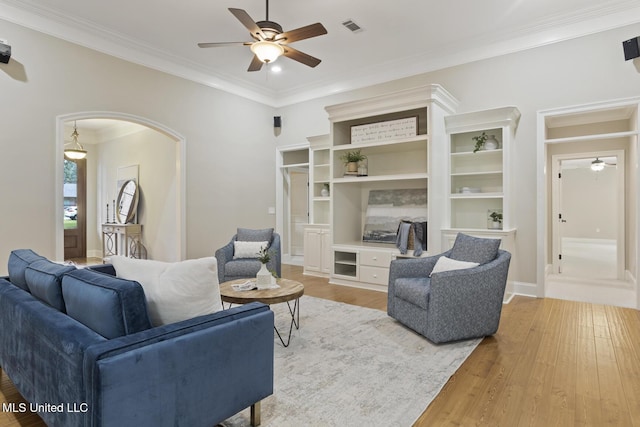 191 N Brandon Blvd, Brandon, MS 39042 - living room with a ceiling fan, crown molding, light wood-type flooring, and arched walkways