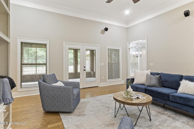 191 N Brandon Blvd, Brandon, MS 39042 - living room with french doors, ornamental molding, ceiling fan, light wood-type flooring, and a towering ceiling