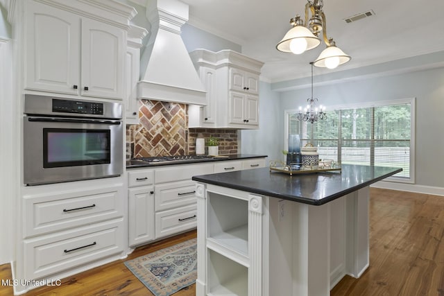 191 N Brandon Blvd, Brandon, MS 39042 - kitchen with stainless steel appliances, custom exhaust hood, dark countertops, tasteful backsplash, and a kitchen island