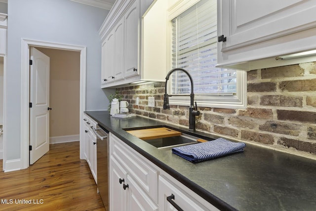 191 N Brandon Blvd, Brandon, MS 39042 - kitchen featuring dark countertops, stainless steel dishwasher, white cabinetry, decorative backsplash, and wood finished floors