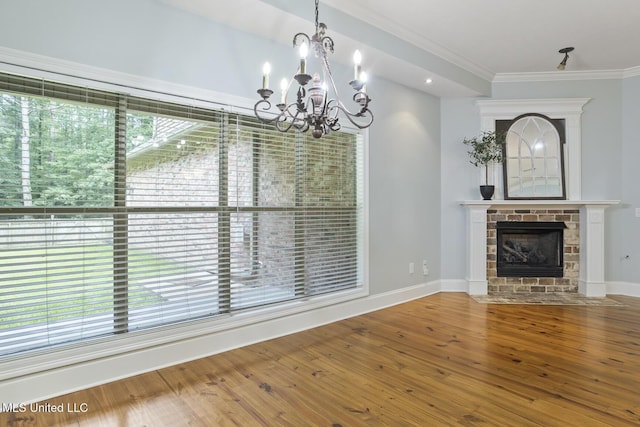 191 N Brandon Blvd, Brandon, MS 39042 - unfurnished dining area featuring a chandelier, wood finished floors, ornamental molding, and a fireplace with flush hearth