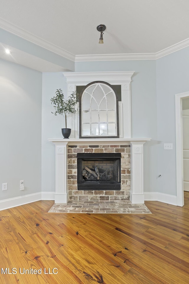 191 N Brandon Blvd, Brandon, MS 39042 - detailed view of wood finished floors, crown molding, and a brick fireplace