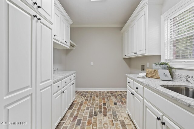 191 N Brandon Blvd, Brandon, MS 39042 - laundry room featuring crown molding, brick floors, cabinet space, and washer hookup