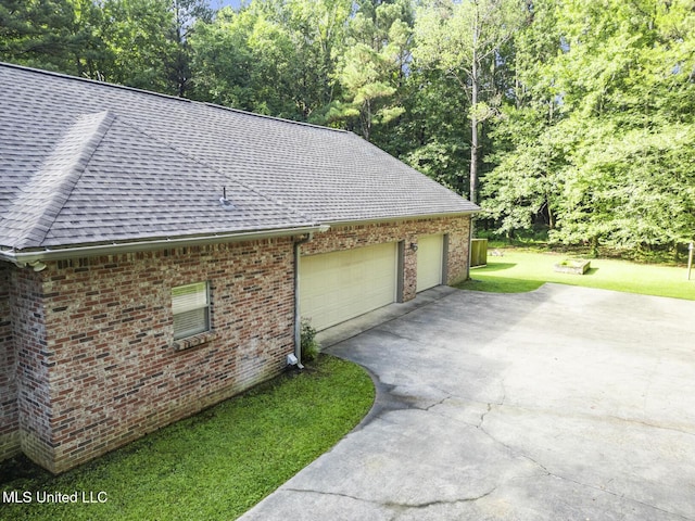 191 N Brandon Blvd, Brandon, MS 39042 - view of property exterior with a shingled roof, brick siding, asphalt driveway, a yard, and an attached garage