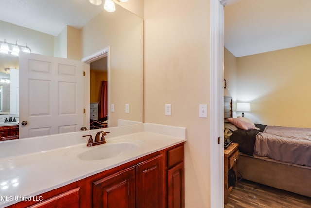 bathroom featuring wood finished floors, ensuite bath, and vanity