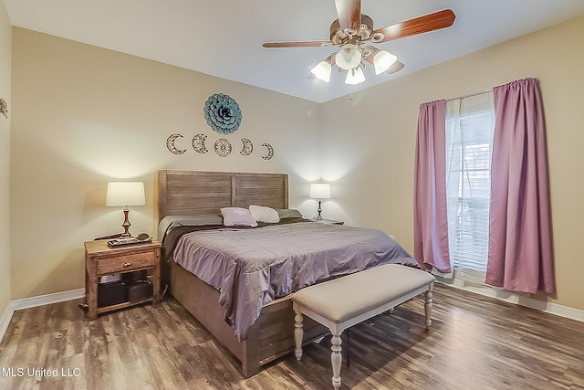 bedroom featuring a ceiling fan, baseboards, and dark wood-type flooring