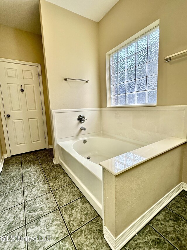 6901 N Rue Mornay, Biloxi, MS 39532 - full bathroom with a garden tub and tile patterned flooring