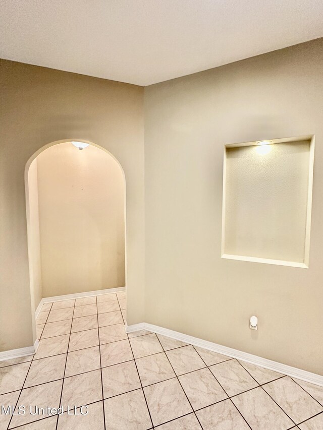 6901 N Rue Mornay, Biloxi, MS 39532 - unfurnished room featuring arched walkways and light tile patterned floors