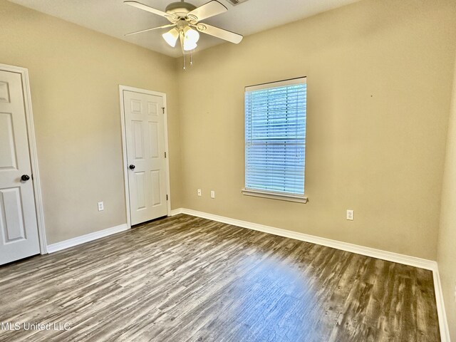 6901 N Rue Mornay, Biloxi, MS 39532 - unfurnished bedroom with wood finished floors and ceiling fan