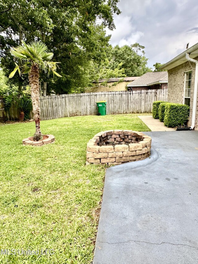 6901 N Rue Mornay, Biloxi, MS 39532 - view of yard with an outdoor fire pit and a patio area