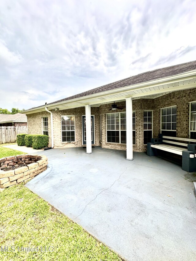 6901 N Rue Mornay, Biloxi, MS 39532 - rear view of property featuring a patio area, ceiling fan, and brick siding