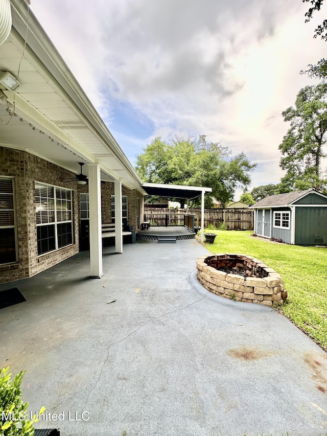 6901 N Rue Mornay, Biloxi, MS 39532 - view of patio with an outdoor fire pit, a shed, and a carport