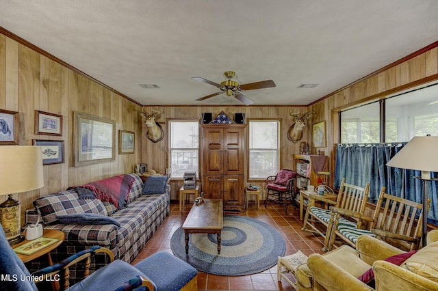 121 Belle Island Dr, Vicksburg, MS 39183 - tiled living room with wood walls, a ceiling fan, and ornamental molding