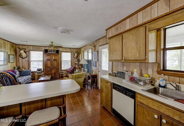 121 Belle Island Dr, Vicksburg, MS 39183 - kitchen with light countertops, open floor plan, wooden walls, dishwasher, and dark tile patterned flooring