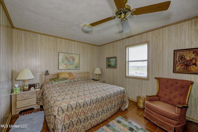 tiled bedroom with ceiling fan, ornamental molding, and a textured ceiling