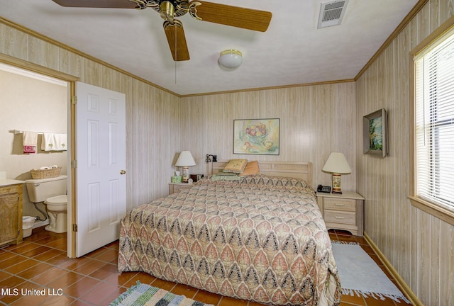 bedroom with connected bathroom, ceiling fan, ornamental molding, and tile patterned flooring