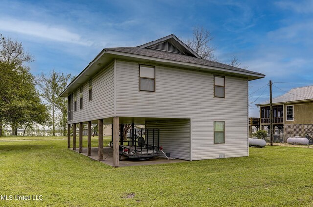 121 Belle Island Dr, Vicksburg, MS 39183 - rear view of property featuring a lawn, roof with shingles, and a patio area