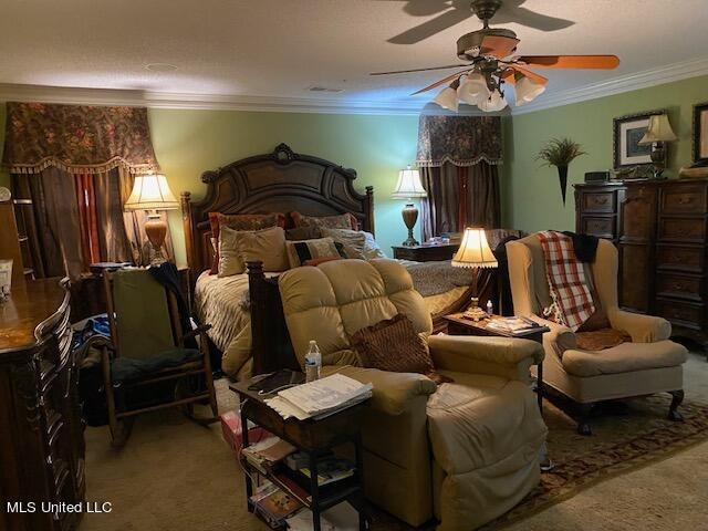 bedroom featuring crown molding, carpet flooring, and ceiling fan