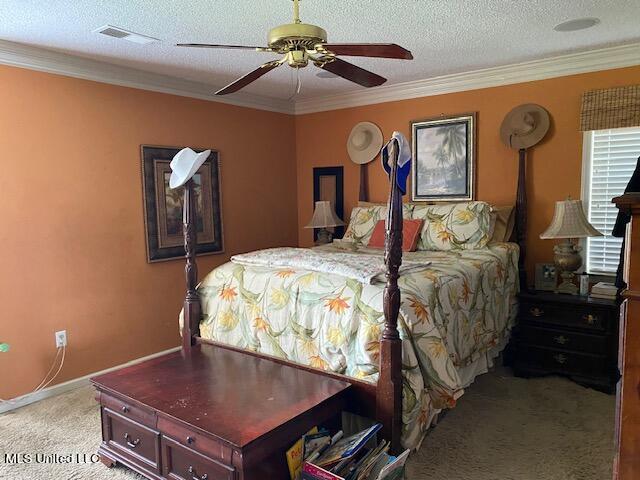 carpeted bedroom with crown molding, a textured ceiling, and ceiling fan