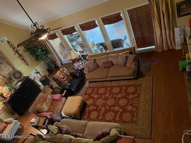 living room featuring ornamental molding, hardwood / wood-style floors, and plenty of natural light