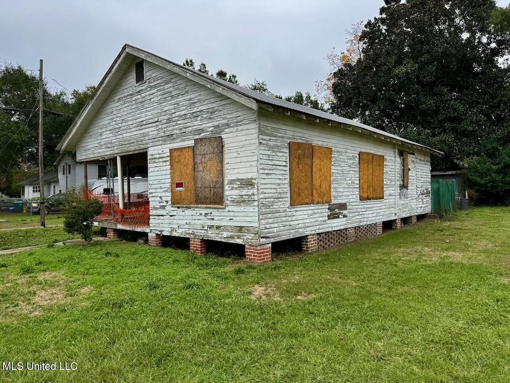 view of home's exterior with a yard